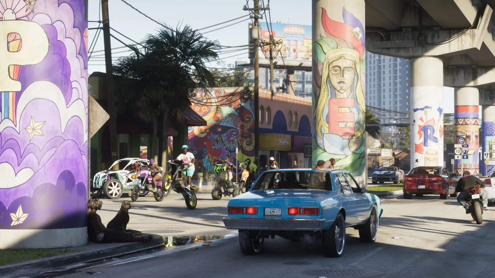 Street life in Vice City, a classic muscle car rolling past hand-painted murals. © Rockstar Games